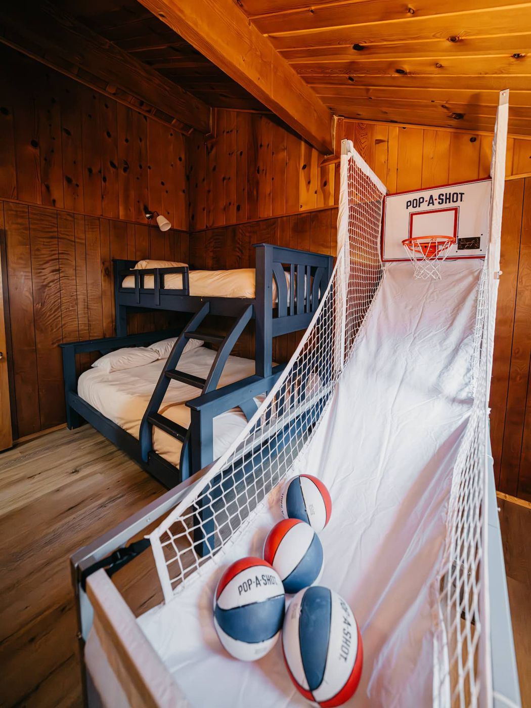 Bunk room with an arcade basketball game